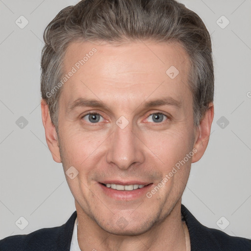 Joyful white adult male with short  brown hair and grey eyes