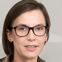 Joyful white young-adult female with medium  brown hair and blue eyes