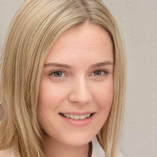 Joyful white young-adult female with long  blond hair and brown eyes