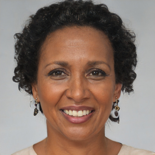 Joyful black adult female with short  brown hair and brown eyes