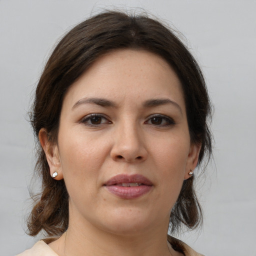 Joyful white young-adult female with medium  brown hair and brown eyes