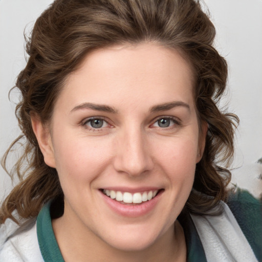 Joyful white young-adult female with medium  brown hair and blue eyes