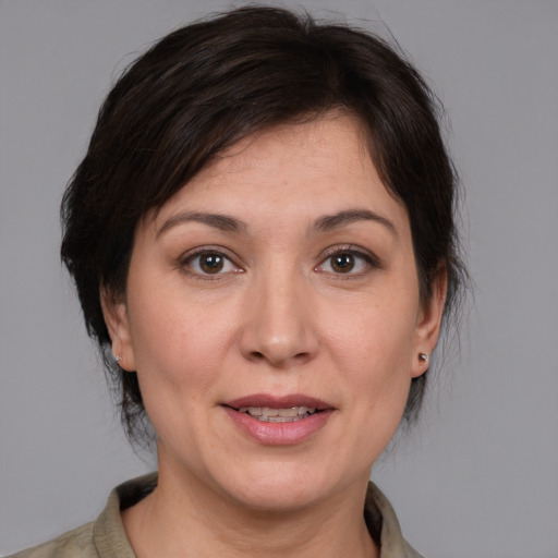 Joyful white adult female with medium  brown hair and brown eyes