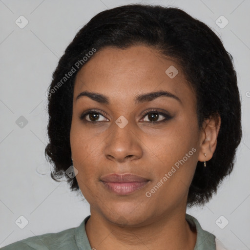 Joyful black young-adult female with short  black hair and brown eyes