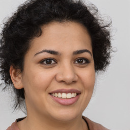 Joyful latino young-adult female with medium  brown hair and brown eyes