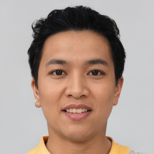 Joyful asian young-adult male with short  black hair and brown eyes