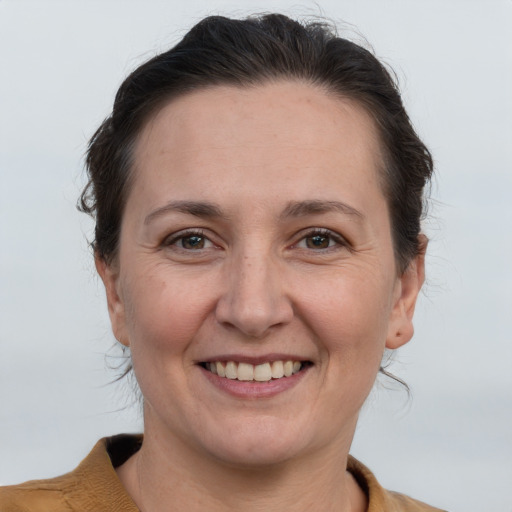 Joyful white adult female with short  brown hair and brown eyes