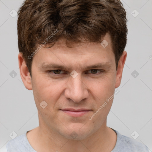 Joyful white young-adult male with short  brown hair and grey eyes