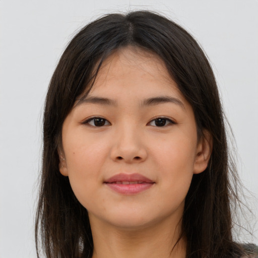 Joyful asian young-adult female with long  brown hair and brown eyes