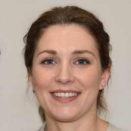 Joyful white young-adult female with medium  brown hair and brown eyes