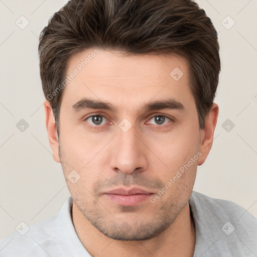 Neutral white young-adult male with short  brown hair and brown eyes