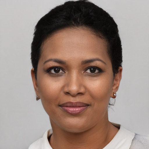 Joyful latino young-adult female with short  black hair and brown eyes