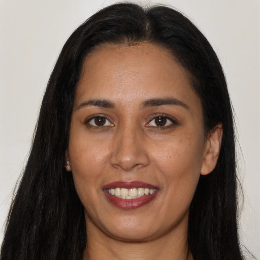 Joyful latino young-adult female with long  black hair and brown eyes