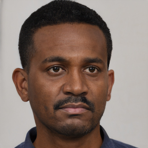 Neutral black young-adult male with short  black hair and brown eyes