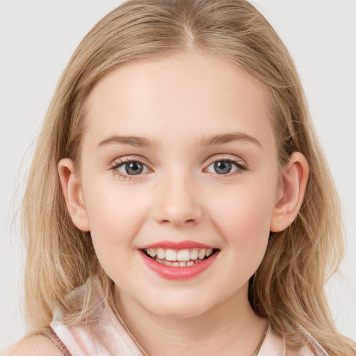 Joyful white child female with long  brown hair and blue eyes