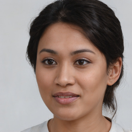 Joyful latino young-adult female with medium  brown hair and brown eyes