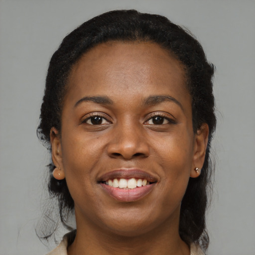 Joyful black young-adult female with medium  brown hair and brown eyes