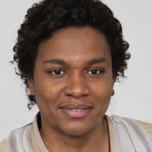 Joyful black young-adult female with short  brown hair and brown eyes
