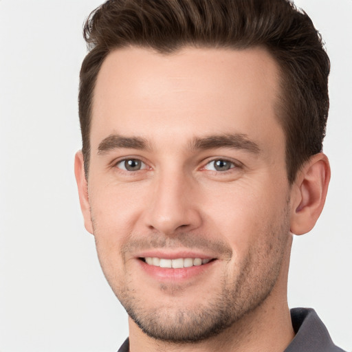 Joyful white young-adult male with short  brown hair and brown eyes