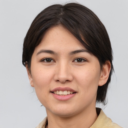 Joyful asian young-adult female with medium  brown hair and brown eyes