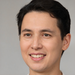 Joyful white young-adult male with short  brown hair and brown eyes