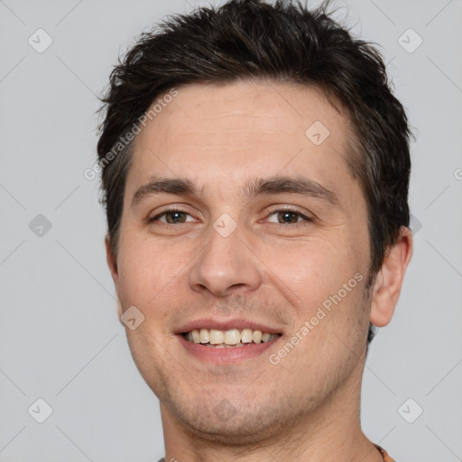 Joyful white adult male with short  brown hair and brown eyes