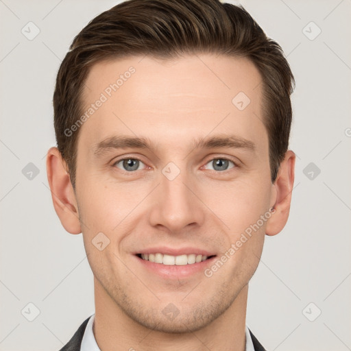 Joyful white young-adult male with short  brown hair and grey eyes