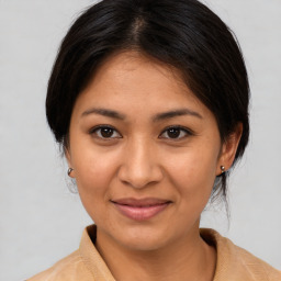 Joyful asian young-adult female with medium  brown hair and brown eyes