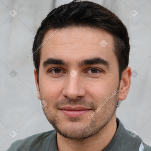 Joyful white young-adult male with short  black hair and brown eyes