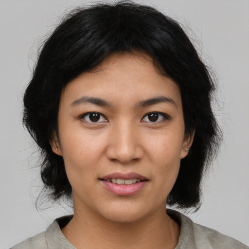Joyful asian young-adult female with medium  black hair and brown eyes