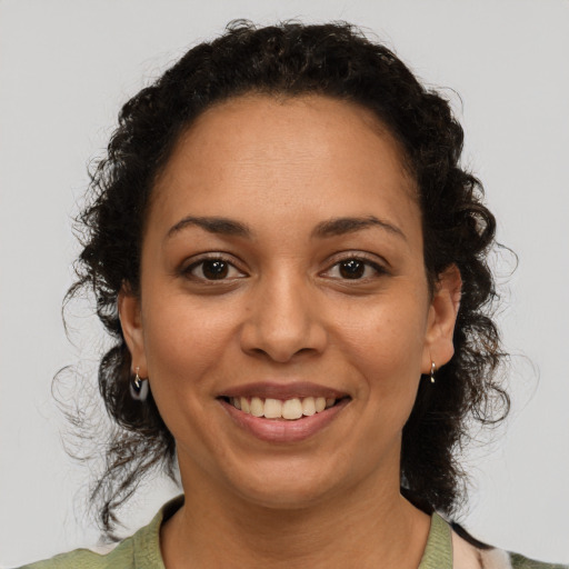 Joyful latino young-adult female with medium  brown hair and brown eyes