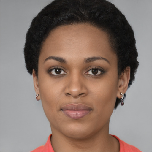 Joyful black young-adult female with short  brown hair and brown eyes