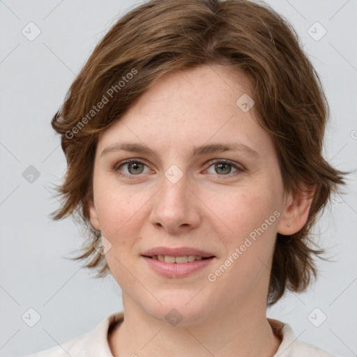 Joyful white young-adult female with medium  brown hair and green eyes