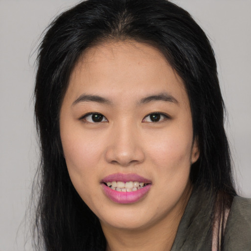 Joyful asian young-adult female with long  brown hair and brown eyes