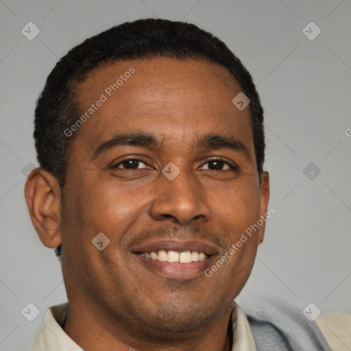 Joyful black young-adult male with short  brown hair and brown eyes