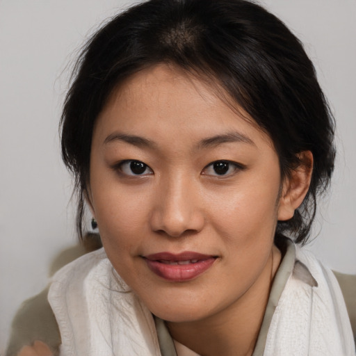 Joyful asian young-adult female with medium  brown hair and brown eyes