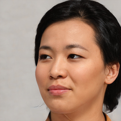 Joyful asian young-adult female with medium  black hair and brown eyes
