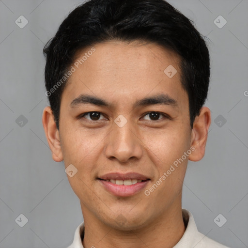 Joyful latino young-adult male with short  brown hair and brown eyes