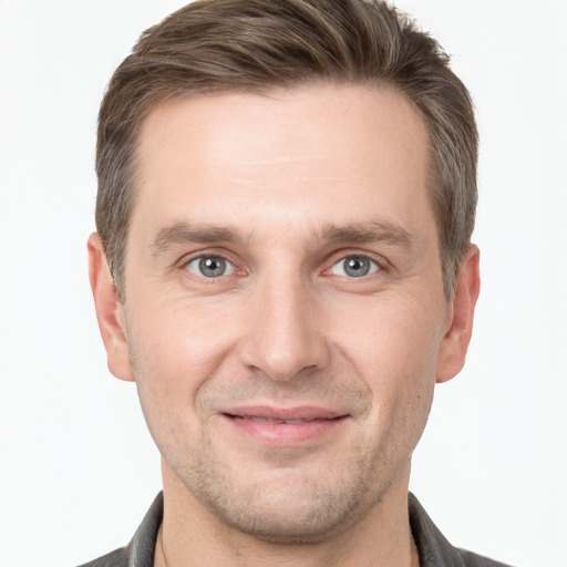 Joyful white adult male with short  brown hair and grey eyes