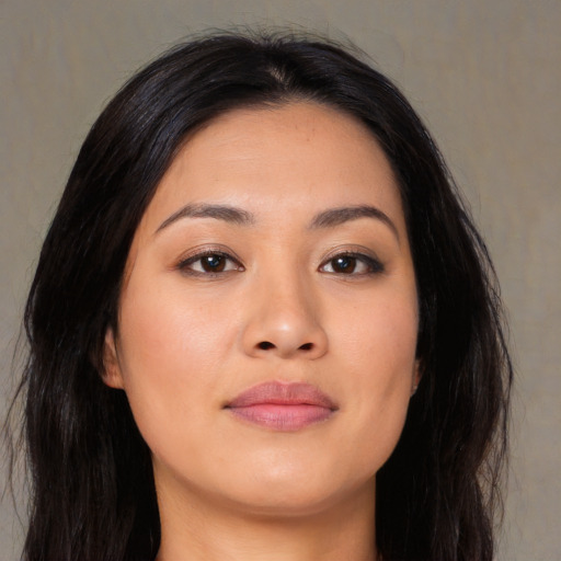 Joyful asian young-adult female with long  brown hair and brown eyes