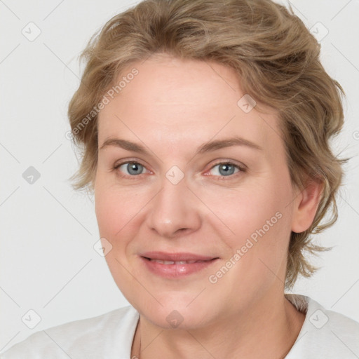 Joyful white adult female with medium  brown hair and blue eyes