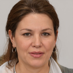 Joyful white adult female with medium  brown hair and brown eyes