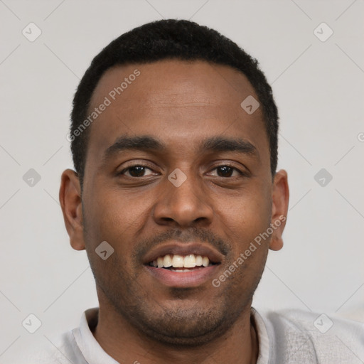 Joyful black young-adult male with short  black hair and brown eyes