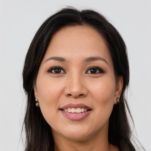 Joyful latino young-adult female with long  brown hair and brown eyes