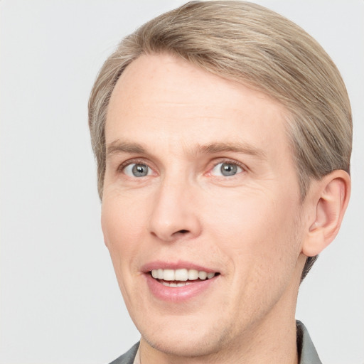 Joyful white adult male with short  brown hair and grey eyes