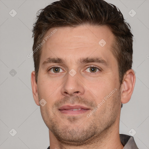 Joyful white adult male with short  brown hair and brown eyes