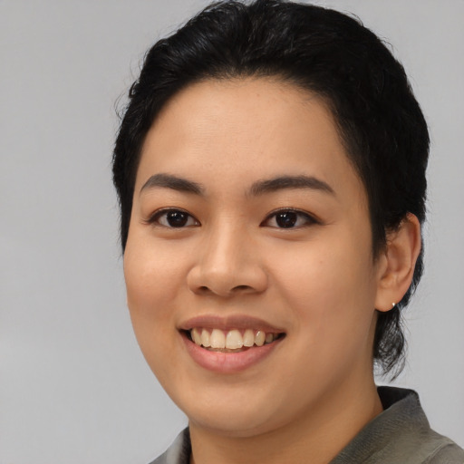 Joyful asian young-adult female with medium  black hair and brown eyes