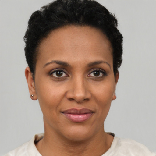 Joyful latino young-adult female with short  black hair and brown eyes