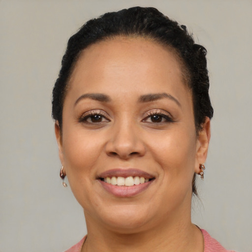 Joyful latino adult female with short  brown hair and brown eyes