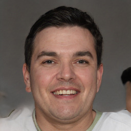 Joyful white adult male with short  brown hair and brown eyes